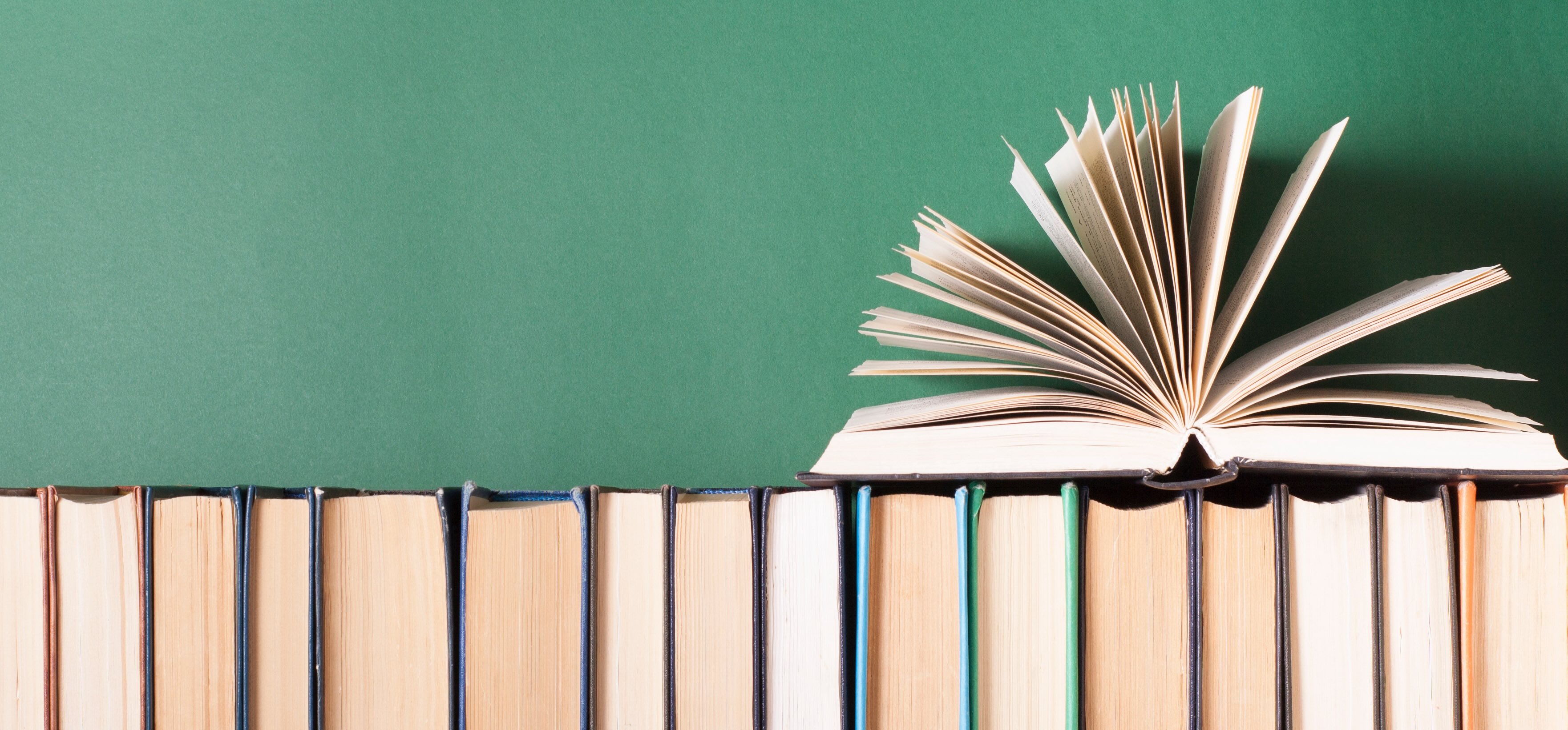 green background with a stack of books